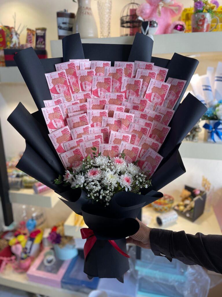 Elegant cash bouquet with white chrysanthemum flowers and baby's breath wrapped in black paper