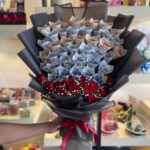 Large cash bouquet with 100000 rupees in various denominations and red roses with baby's breath