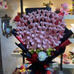 Artificial red roses cash bouquet with Ferrero Rocher chocolates wrapped in black paper