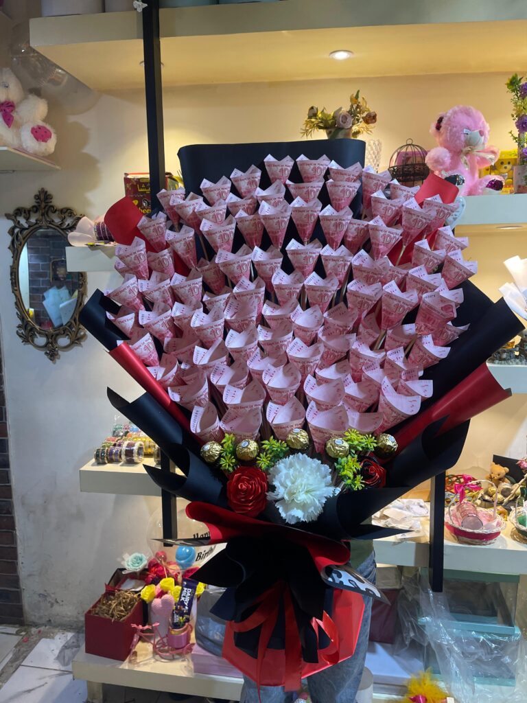 Artificial red roses cash bouquet with Ferrero Rocher chocolates wrapped in black paper